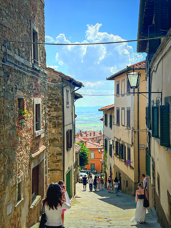 Students from The Creative School tour the cobblestone streets of Cortona led by a local guide.
